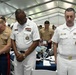 U.S. Navy Sailors and U.S. Marines bow their heads during the invocation at the Parade of Ships VIP breakfast