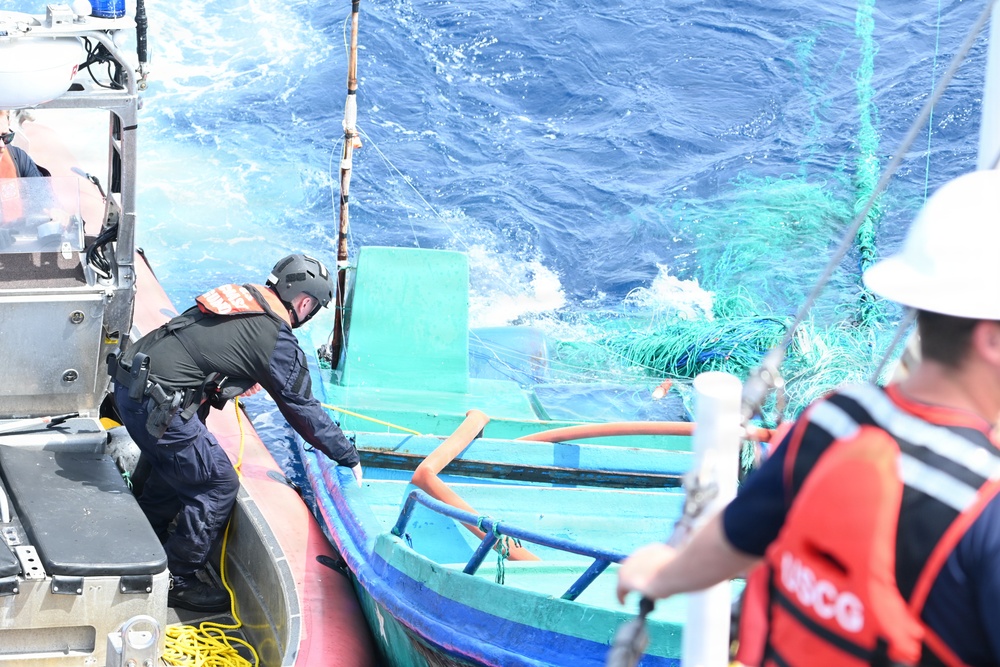 Coast Guard Cutter Tampa crew members dewater, right capsized panga during interdiction in the Eastern Pacific Ocean