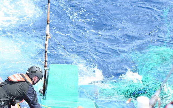 Coast Guard Cutter Tampa crew members dewater, right capsized panga during interdiction in the Eastern Pacific Ocean