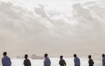 U.S. Sailors and Marines man the rails on the USS Kearsarge