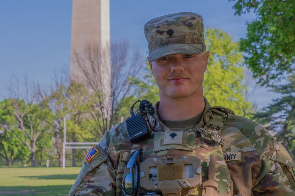 A Mississippi National Guard Soldier helps a member of the public at the Credit Union Cherry Blossom Ten Mile Run