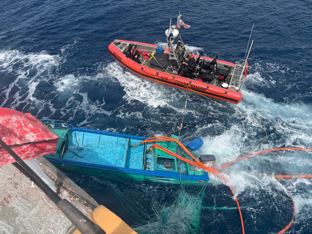 Coast Guard Cutter Tampa crew members dewater, right capsized panga during interdiction in the Eastern Pacific Ocean