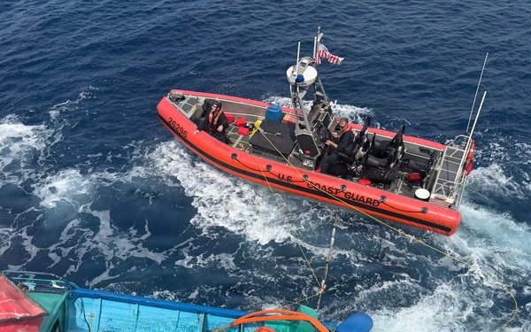 Coast Guard Cutter Tampa crew members dewater, right capsized panga during interdiction in the Eastern Pacific Ocean