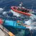 Coast Guard Cutter Tampa crew members dewater, right capsized panga during interdiction in the Eastern Pacific Ocean