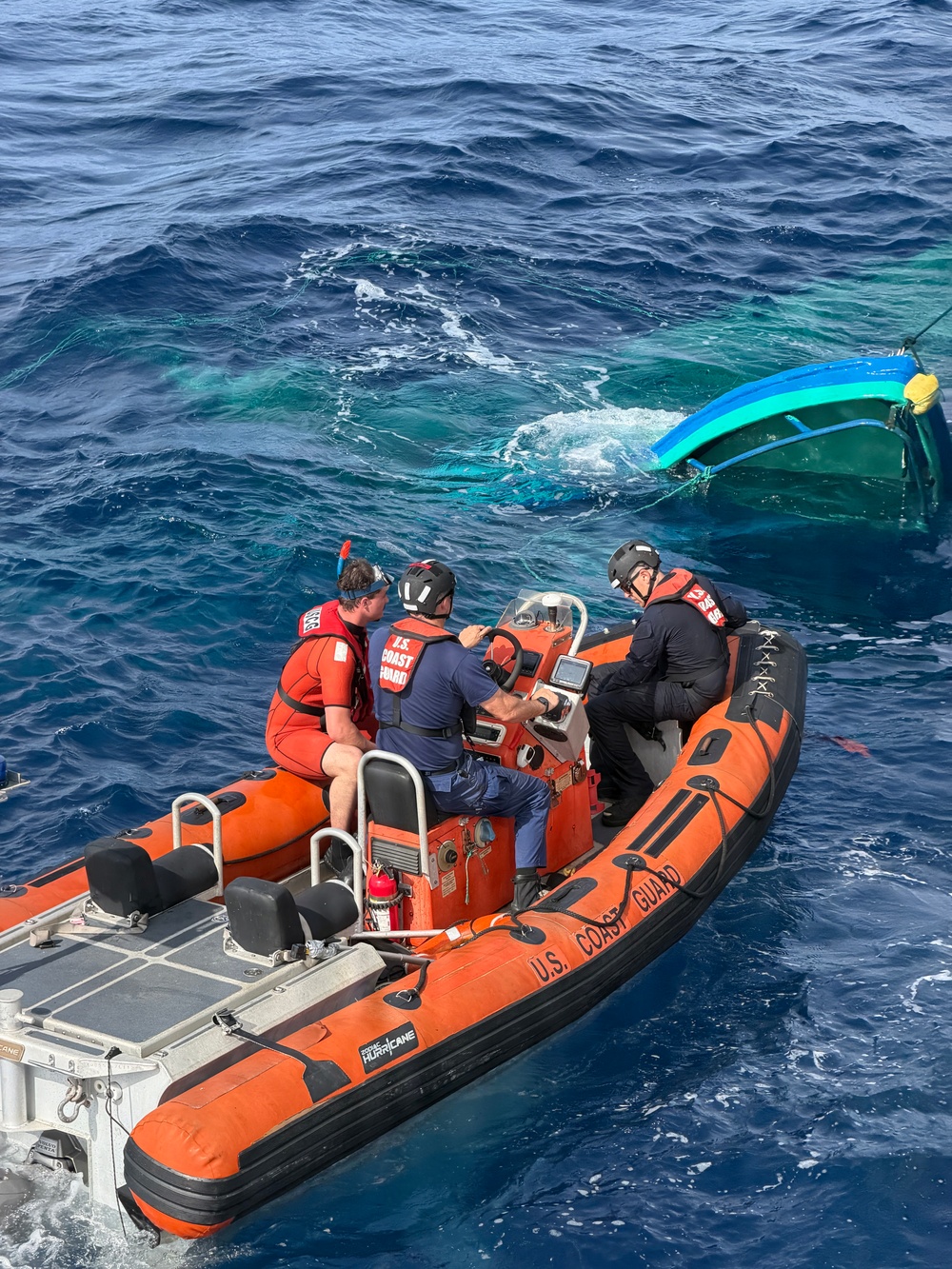 Coast Guard Cutter Tampa crew members dewater, right capsized panga during interdiction in the Eastern Pacific Ocean