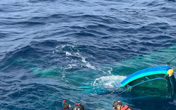 Coast Guard Cutter Tampa crew members dewater, right capsized panga during interdiction in the Eastern Pacific Ocean