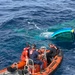 Coast Guard Cutter Tampa crew members dewater, right capsized panga during interdiction in the Eastern Pacific Ocean