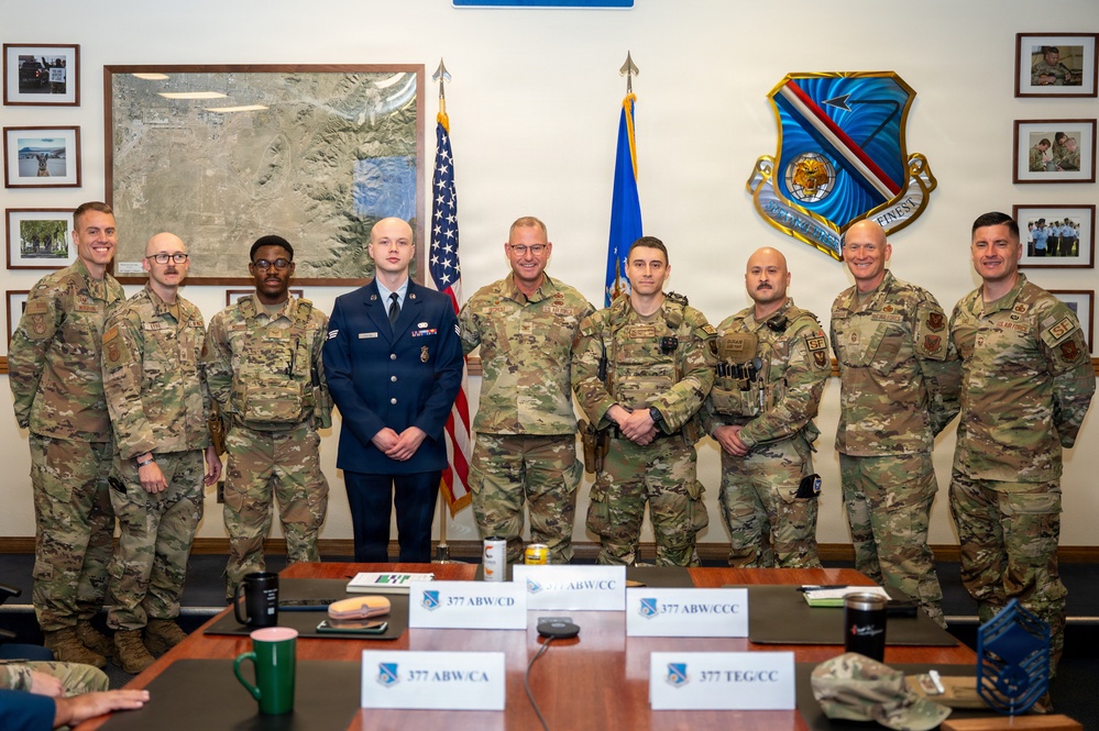 Col. Justin Secrest, 377th Air Base Wing and installation commander poses for a group photo with Kirtland Air Force Base Defenders