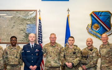 Col. Justin Secrest, 377th Air Base Wing and installation commander poses for a group photo with Kirtland Air Force Base Defenders