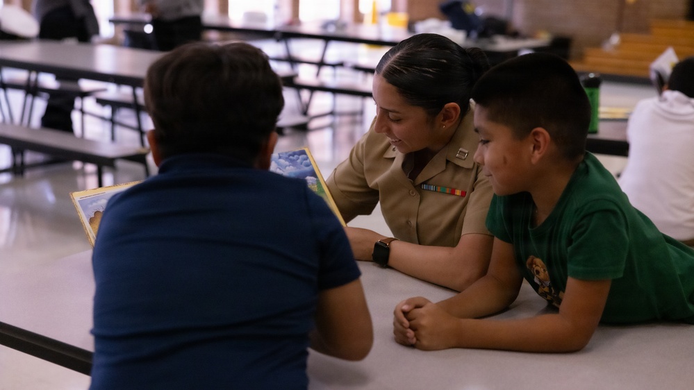 U.S. service members and Houston Texans engage with students at Law Elementary School