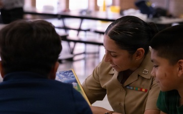 U.S. service members and Houston Texans engage with students at Law Elementary School