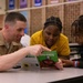 U.S. service members and Houston Texans engage with students at Law Elementary School