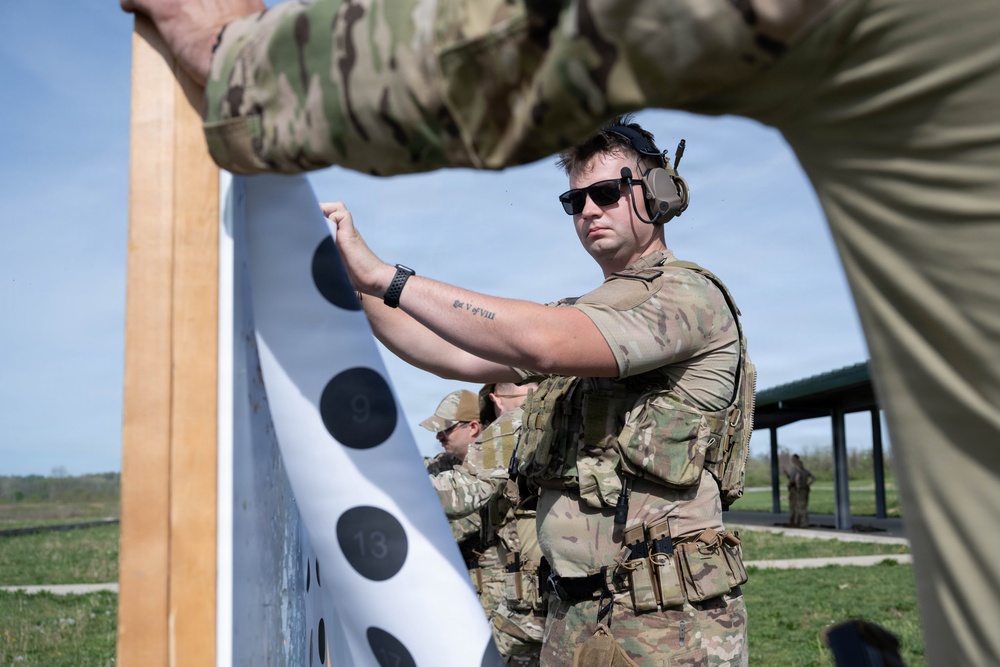 Airmen from the 113th Contingency Response Squadron fire M18 Sig Sauer handguns and transition with M4A1 carbine rifles at Camp Atterbury