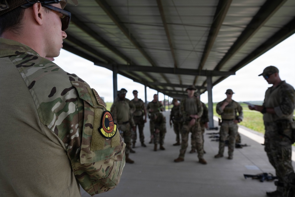 Airmen from the 113th Contingency Response Squadron fire M18 Sig Sauer handguns and transition with M4A1 carbine rifles at Camp Atterbury