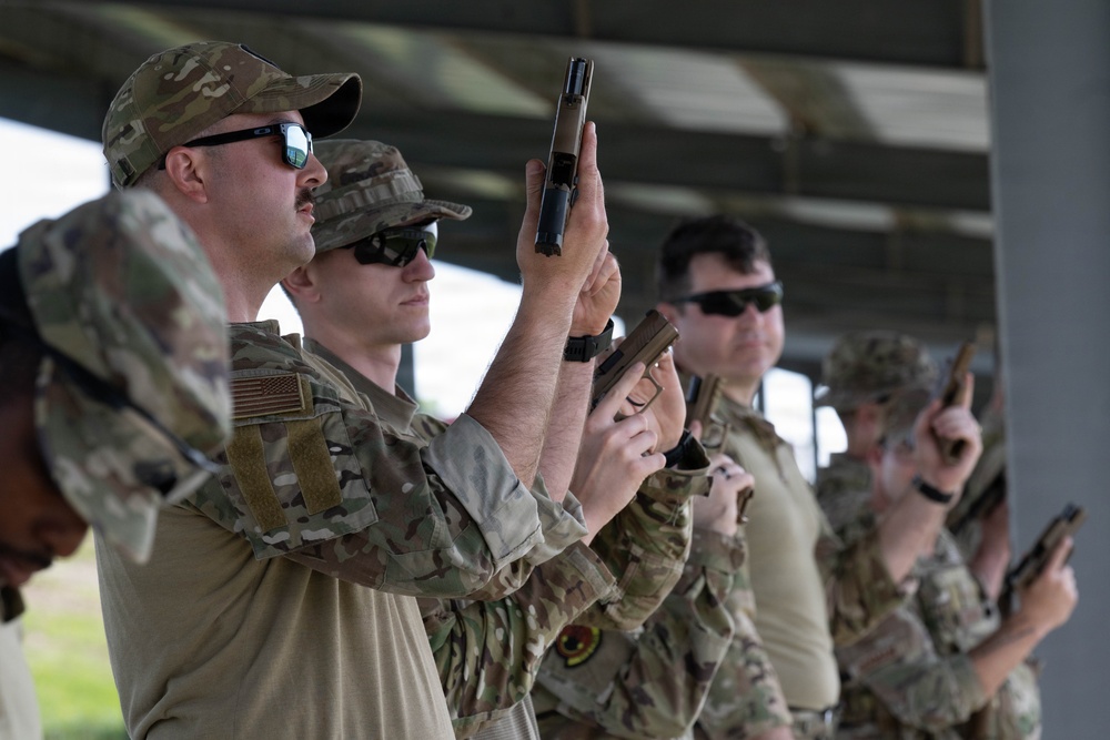 Airmen from the 113th Contingency Response Squadron fire M18 Sig Sauer handguns and transition with M4A1 carbine rifles at Camp Atterbury