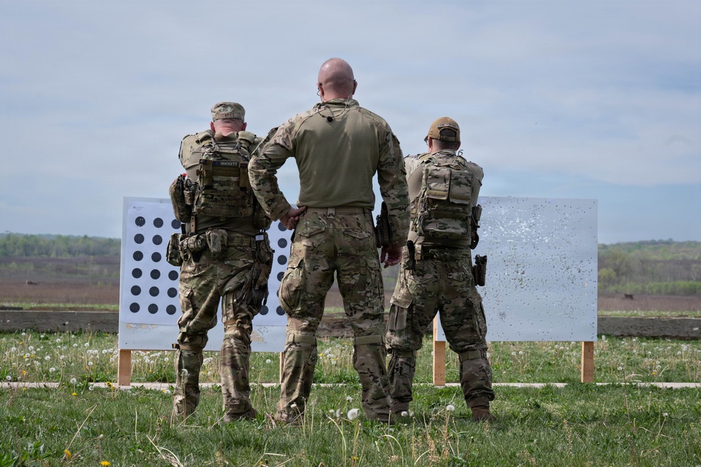 Airmen from the 113th Contingency Response Squadron fire M18 Sig Sauer handguns and transition with M4A1 carbine rifles at Camp Atterbury