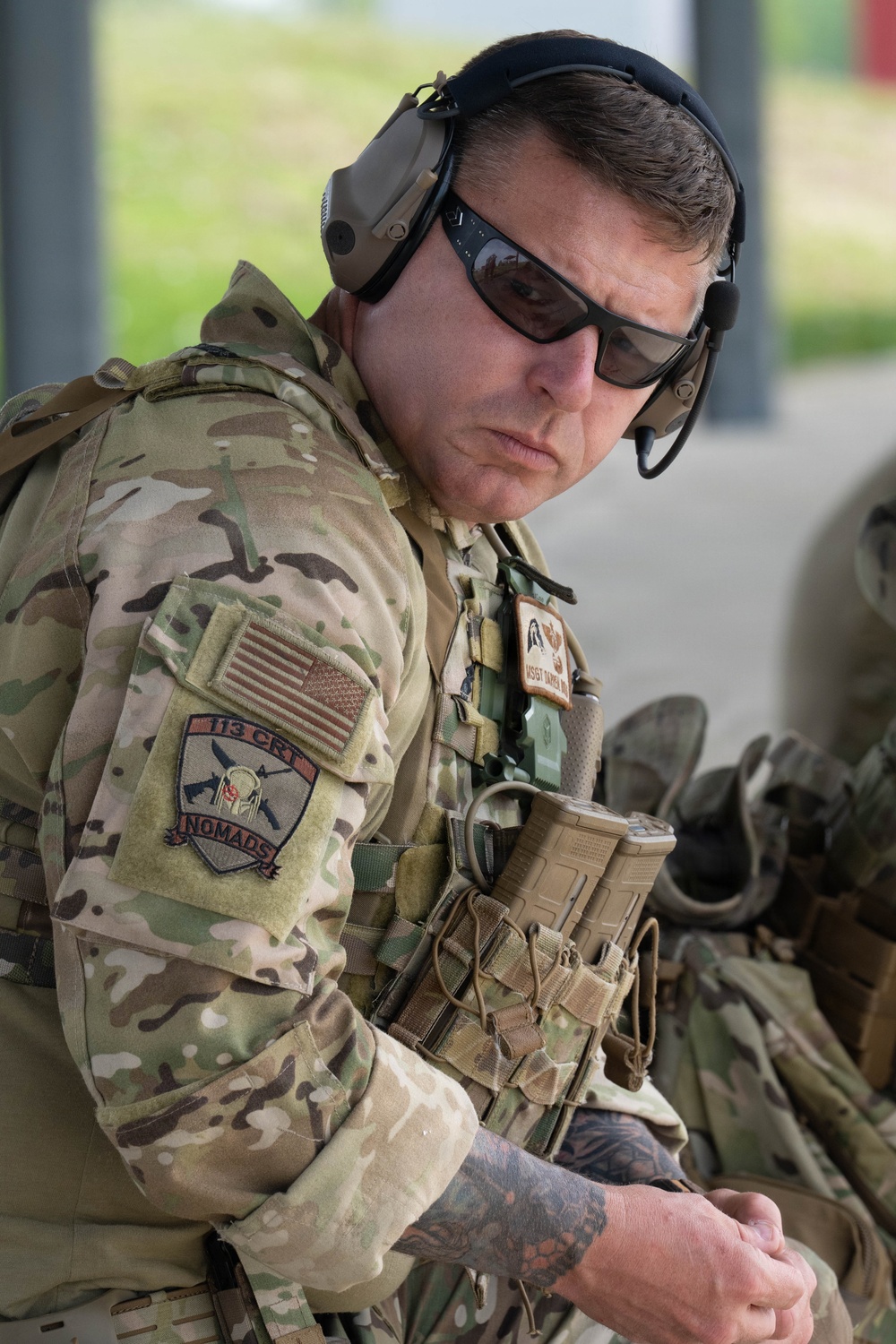 Airmen from the 113th Contingency Response Squadron fire M18 Sig Sauer handguns and transition with M4A1 carbine rifles at Camp Atterbury