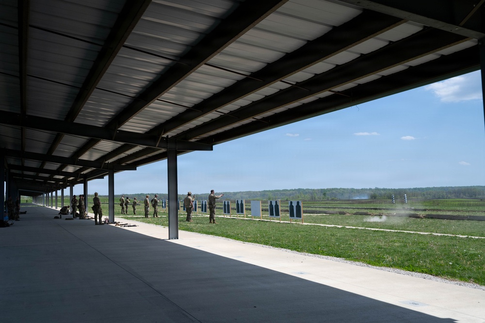 Airmen from the 113th Contingency Response Squadron fire M18 Sig Sauer handguns and transition with M4A1 carbine rifles at Camp Atterbury