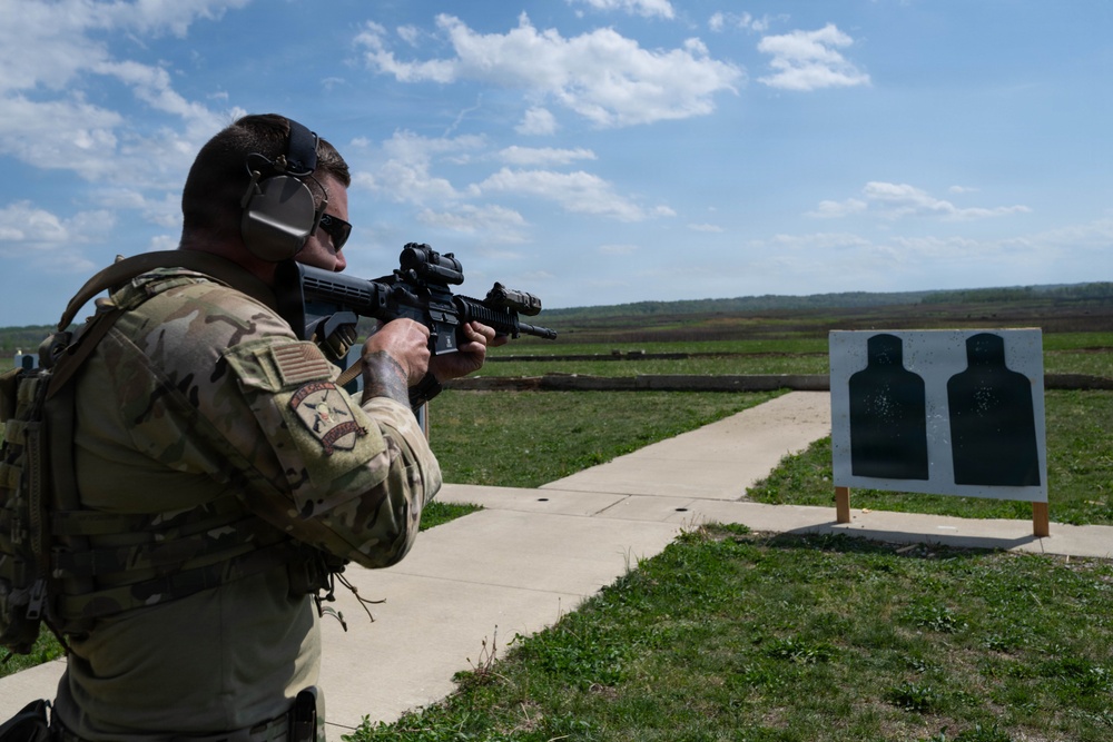 Airmen from the 113th Contingency Response Squadron fire M18 Sig Sauer handguns and transition with M4A1 carbine rifles at Camp Atterbury