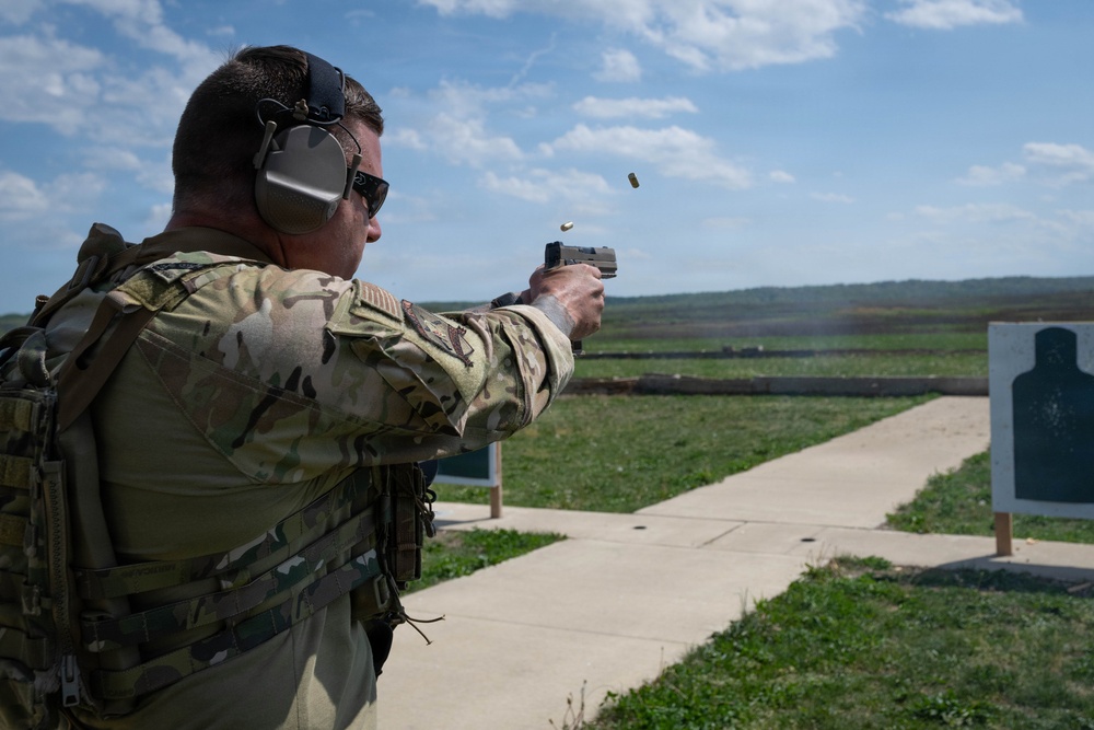 Airmen from the 113th Contingency Response Squadron fire M18 Sig Sauer handguns and transition with M4A1 carbine rifles at Camp Atterbury
