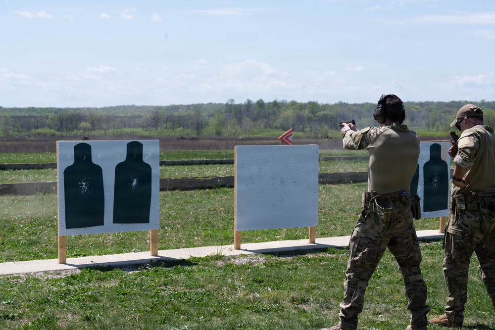 Airmen from the 113th Contingency Response Squadron fire M18 Sig Sauer handguns and transition with M4A1 carbine rifles at Camp Atterbury