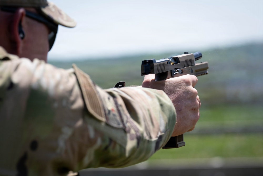 Airmen from the 113th Contingency Response Squadron fire M18 Sig Sauer handguns and transition with M4A1 carbine rifles at Camp Atterbury