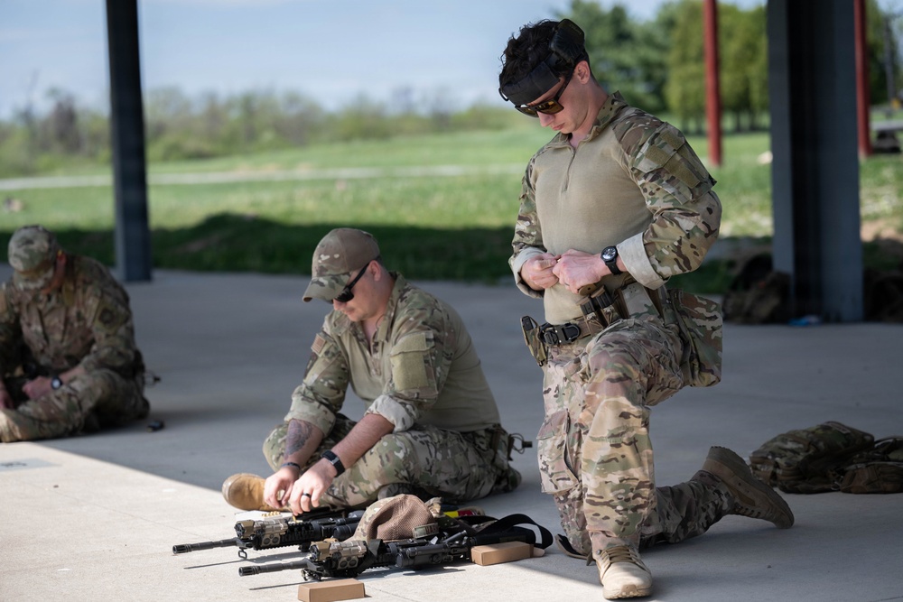 Airmen from the 113th Contingency Response Squadron fire M18 Sig Sauer handguns and transition with M4A1 carbine rifles at Camp Atterbury