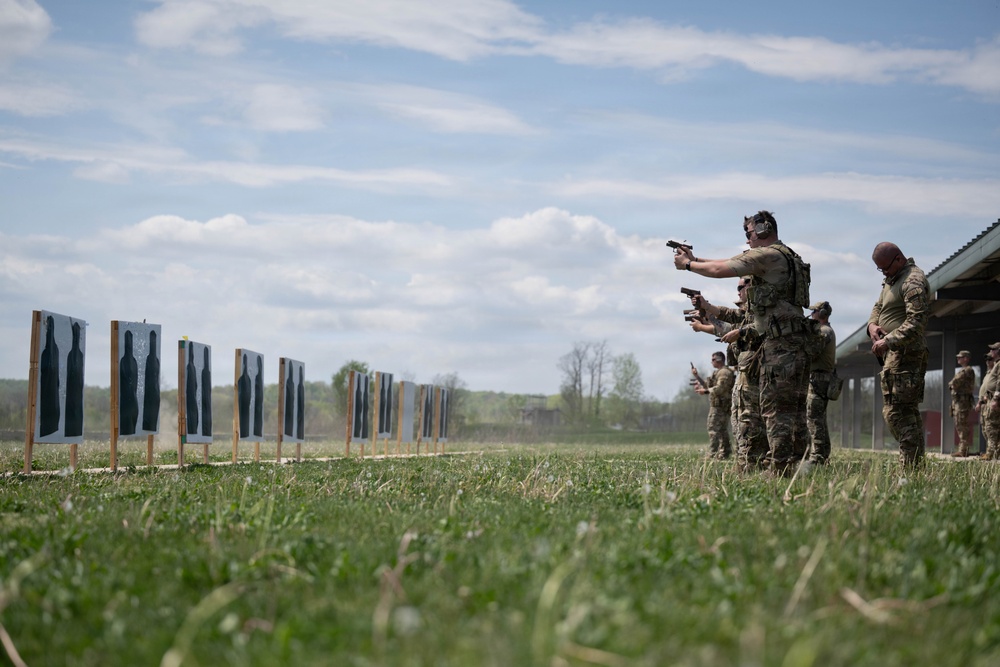 Airmen from the 113th Contingency Response Squadron fire M18 Sig Sauer handguns and transition with M4A1 carbine rifles at Camp Atterbury