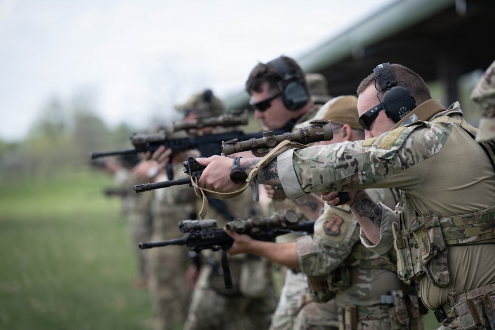 Airmen from the 113th Contingency Response Squadron fire M18 Sig Sauer handguns and transition with M4A1 carbine rifles at Camp Atterbury