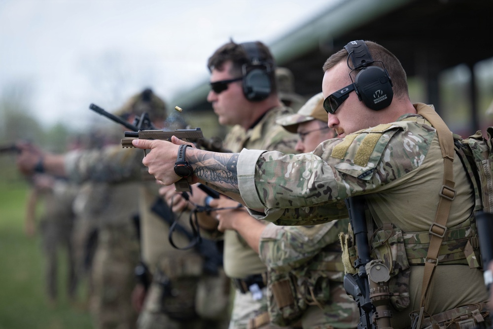 Airmen from the 113th Contingency Response Squadron fire M18 Sig Sauer handguns and transition with M4A1 carbine rifles at Camp Atterbury