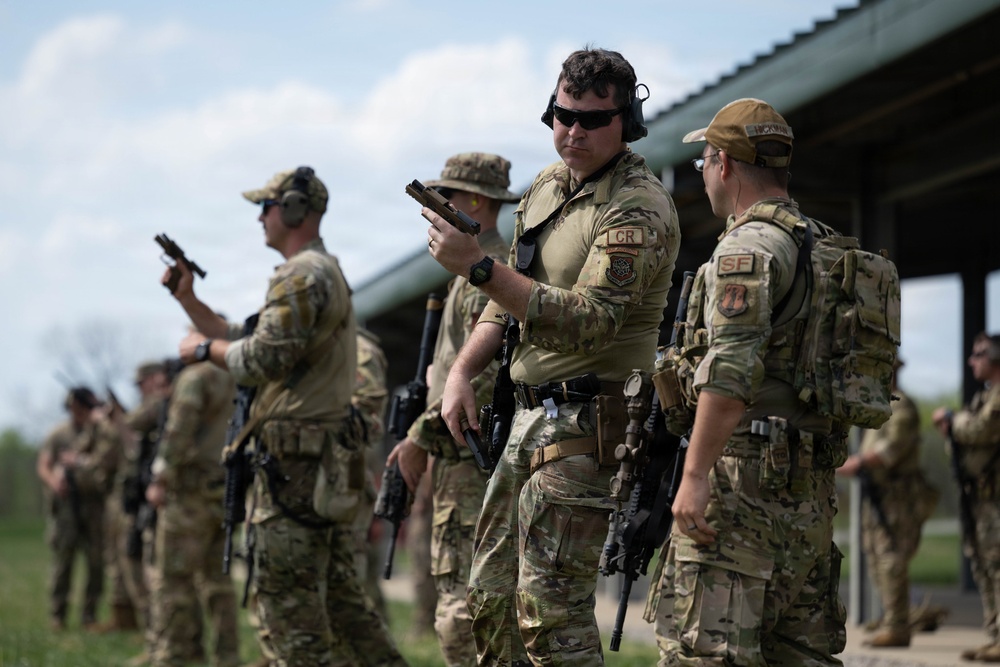 Airmen from the 113th Contingency Response Squadron fire M18 Sig Sauer handguns and transition with M4A1 carbine rifles at Camp Atterbury