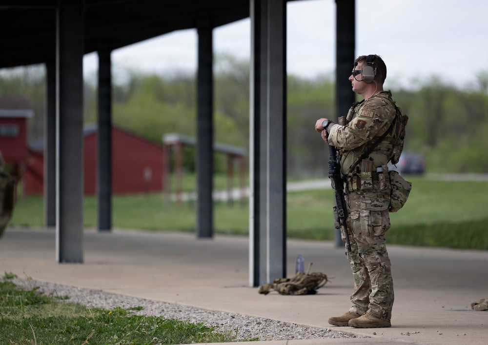 Airmen from the 113th Contingency Response Squadron fire M18 Sig Sauer handguns and transition with M4A1 carbine rifles at Camp Atterbury