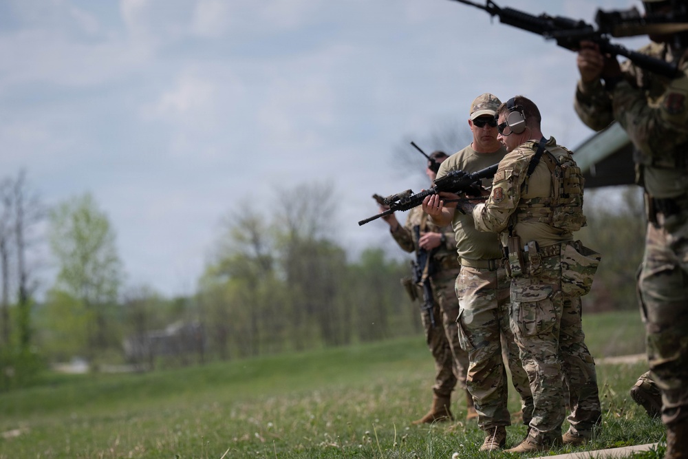 Airmen from the 113th Contingency Response Squadron fire M18 Sig Sauer handguns and transition with M4A1 carbine rifles at Camp Atterbury