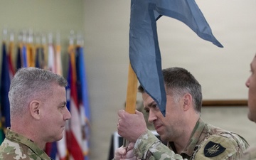 Col. Andrew Walsh passes the 304th Cyber Battalion's colors to Lt. Col. Joel Joyce during the battalion's Change of Command Ceremony at Camp Parks, Calif., on April 11, 2026.