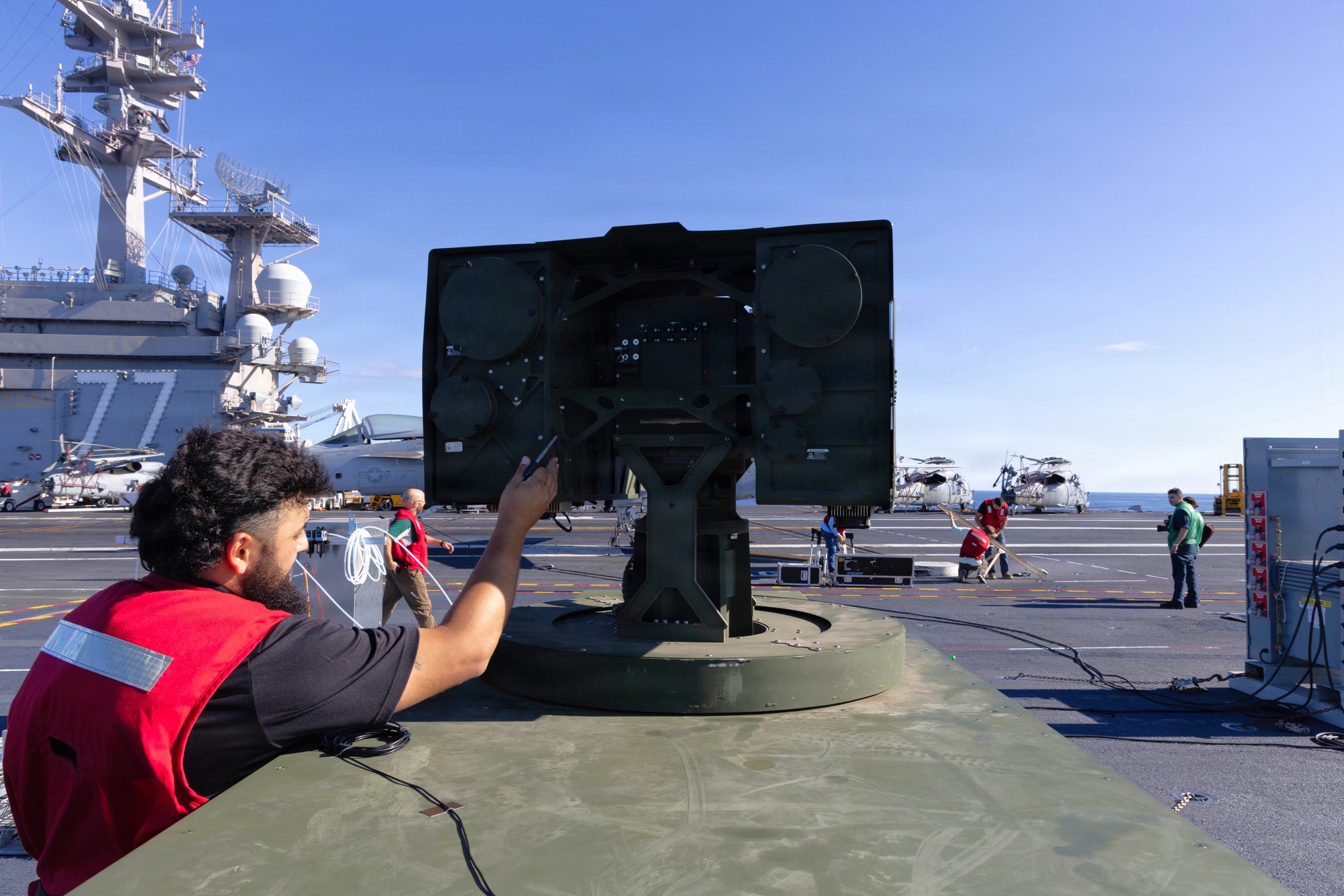 Joint Navy, Army, and AeroVironment team adjusts LOCUST laser system, file photo