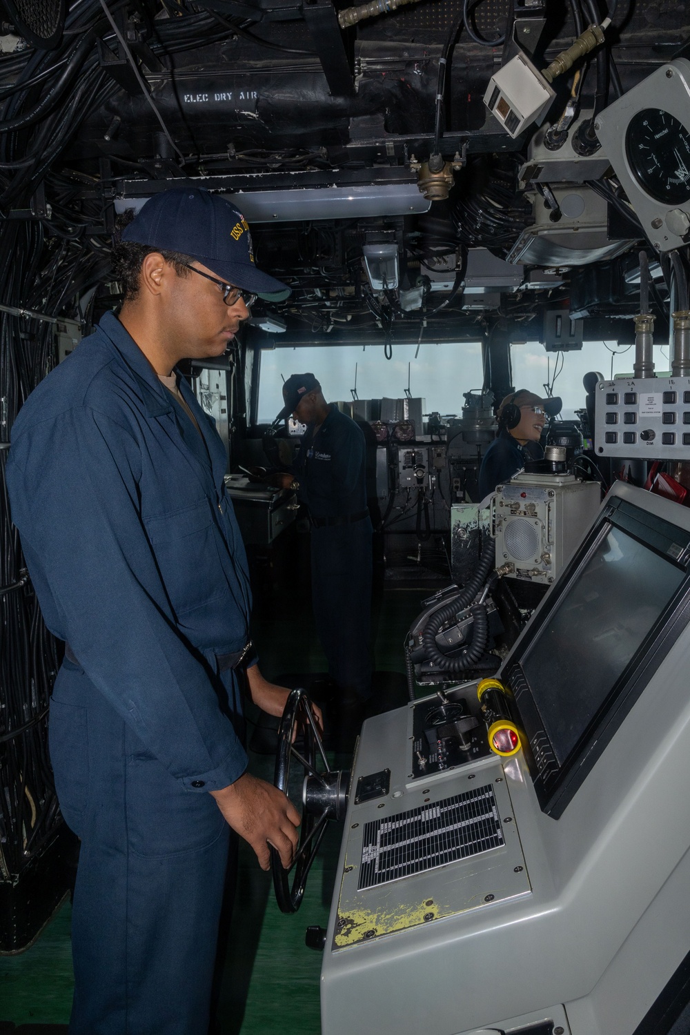 USS Iwo Jima Sailor Steers the Ship