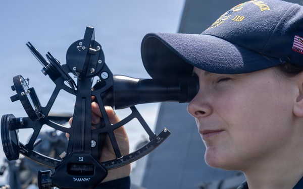 U.S Sailors stand a bridge aboard USS Delbert D. Black (DDG 119)