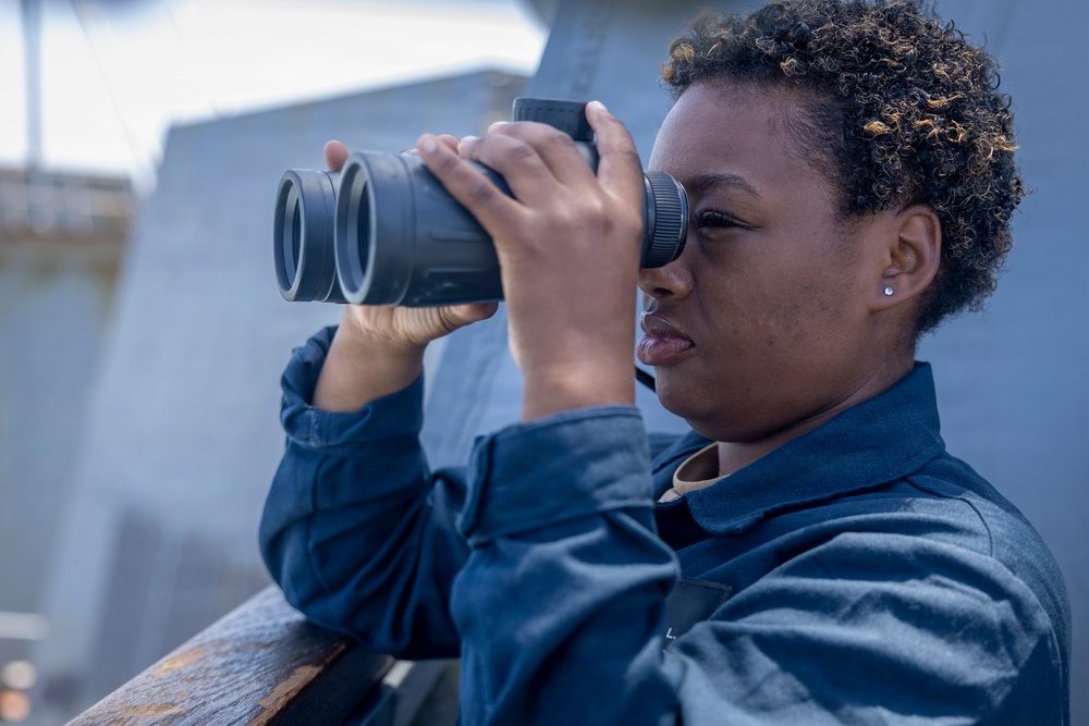 U.S Sailors stand a bridge aboard USS Delbert D. Black (DDG 119)