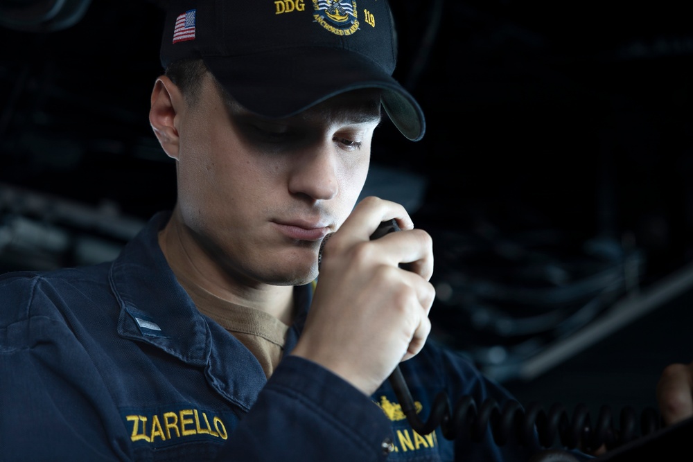 U.S Sailors stand a bridge aboard USS Delbert D. Black (DDG 119)