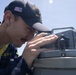 U.S Sailors stand a bridge aboard USS Delbert D. Black (DDG 119)