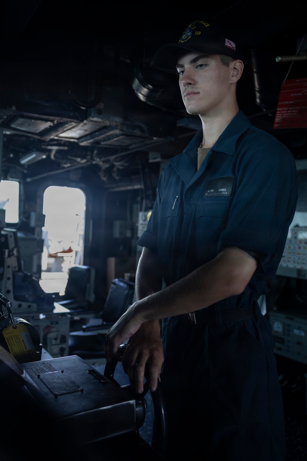 U.S Sailors stand a bridge aboard USS Delbert D. Black (DDG 119)