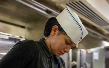 PCU John F. Kennedy Sailor Prepares Lunch