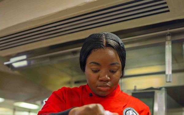 PCU John F. Kennedy Sailor Prepares Lunch