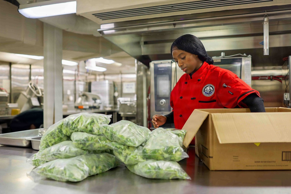 PCU John F. Kennedy Sailor Prepares Lunch