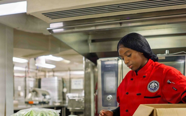 PCU John F. Kennedy Sailor Prepares Lunch