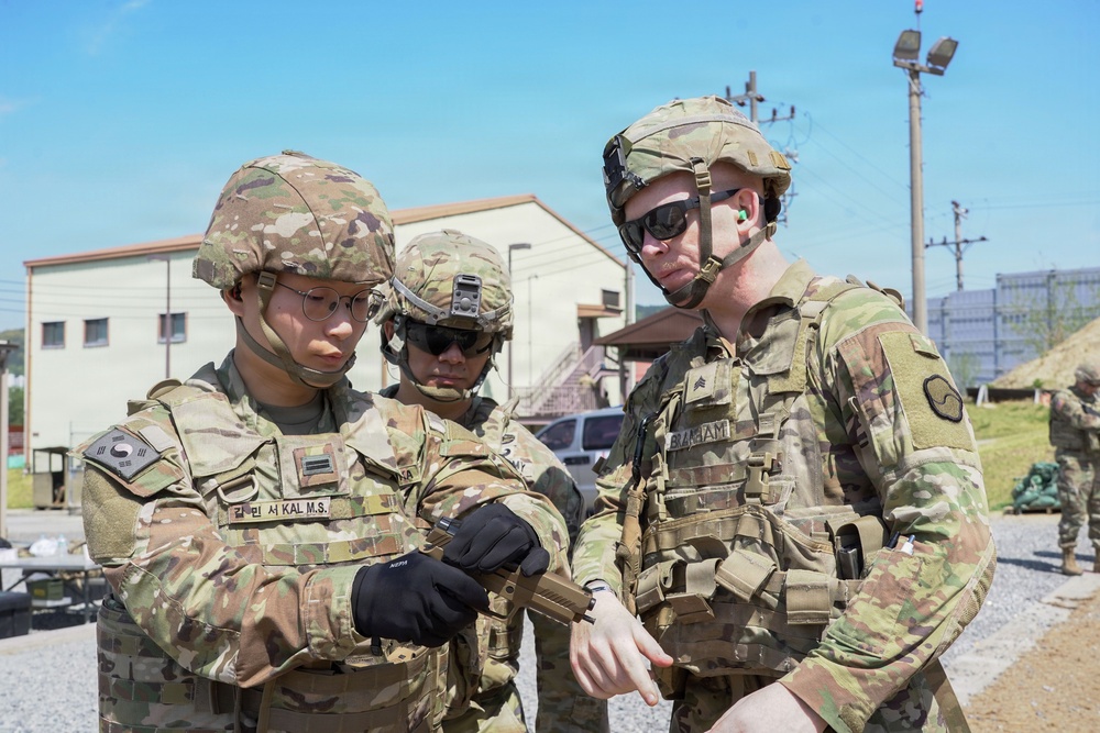 Soldier receives guidance on properly clearing weapon after live-fire iteration