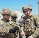 Soldier receives guidance on properly clearing weapon after live-fire iteration
