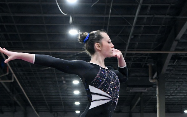 DoWEA Lejeune High School junior performs on the balance beam during a gymnastics competition