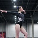 DoWEA Lejeune High School junior performs on the balance beam during a gymnastics competition
