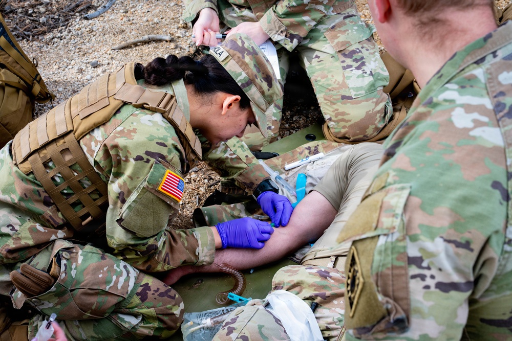 Medics perform medical assessment on casualty
